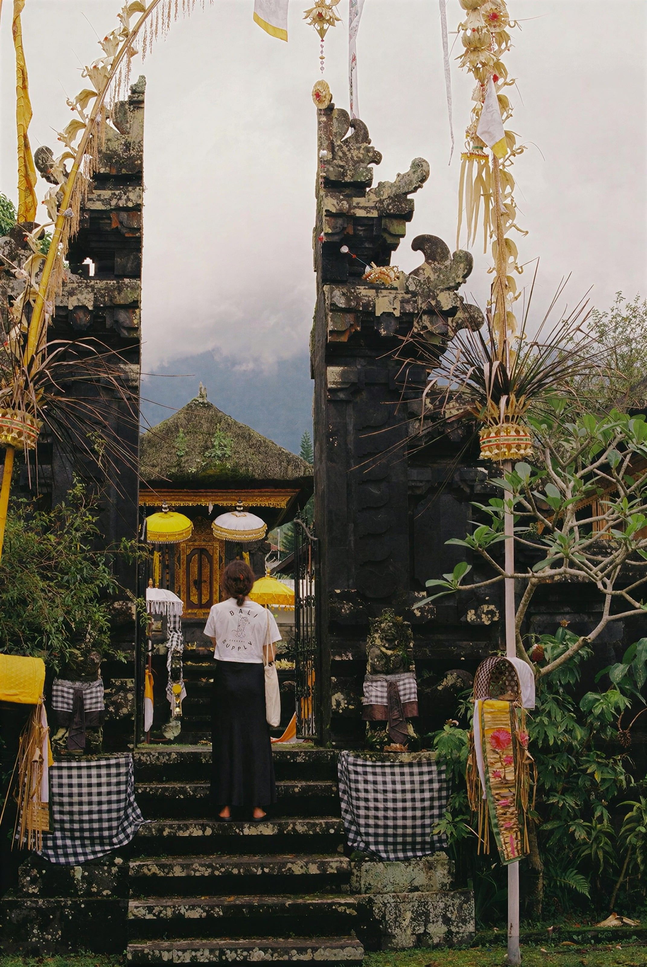 Guests climbing the steps of a carved Balinese temple gate